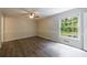 Bedroom showcasing laminate floors, a ceiling fan, and bright window at 135 Pheasant Se Dr, Marietta, GA 30067