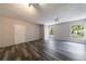 Bedroom featuring neutral walls, wood-look floors, bright windows and natural light, and a double door closet at 135 Pheasant Se Dr, Marietta, GA 30067