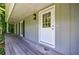 Covered front porch of a home with a white door and dark shutters at 135 Pheasant Se Dr, Marietta, GA 30067