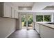 Kitchen featuring white cabinets, eat-in counter, and sliding glass doors leading to the backyard at 135 Pheasant Se Dr, Marietta, GA 30067