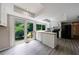 Bright kitchen with modern white cabinets, island, and backyard views through sliding glass door at 135 Pheasant Se Dr, Marietta, GA 30067