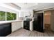 Kitchen showcasing modern appliances, white cabinets, and a large window overlooking the backyard at 135 Pheasant Se Dr, Marietta, GA 30067