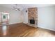 Open living room featuring hardwood floors, brick fireplace, and a ceiling fan at 135 Pheasant Se Dr, Marietta, GA 30067
