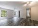 Bright living room featuring neutral walls, wood-look floors, bright windows and natural light, and access to kitchen at 135 Pheasant Se Dr, Marietta, GA 30067