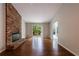 Bright living room features a fireplace, hardwood floors and sliding glass door to the patio at 135 Pheasant Se Dr, Marietta, GA 30067