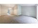 Open living room featuring neutral paint, plush carpet, and outdoor view through the doorway at 135 Pheasant Se Dr, Marietta, GA 30067