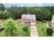 Aerial view of a two-story brick home with a large yard and mature trees in a residential area at 1709 Grove Se Ct, Conyers, GA 30013