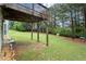 Expansive backyard view from under the wooden deck shows lush greenery and mature trees at 1709 Grove Se Ct, Conyers, GA 30013