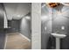 A simple basement bathroom with a pedestal sink, light fixture, and entry into a utility room at 1709 Grove Se Ct, Conyers, GA 30013