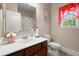 Cozy bathroom featuring a white sink vanity and a window providing natural light at 1709 Grove Se Ct, Conyers, GA 30013