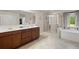 Bathroom with double sink vanity, walk-in shower, and soaking tub at 1709 Grove Se Ct, Conyers, GA 30013