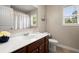 Bright bathroom featuring a wooden vanity, white countertop, and a shower-tub combination at 1709 Grove Se Ct, Conyers, GA 30013