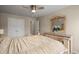 Bedroom featuring a large bed, decorative dresser, a ceiling fan and ample natural light at 1709 Grove Se Ct, Conyers, GA 30013