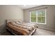Comfortable bedroom featuring a large window and soft neutral decor for a serene retreat at 1709 Grove Se Ct, Conyers, GA 30013