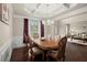 Elegant dining room boasting a coffered ceiling, hardwood floors, and a large window at 1709 Grove Se Ct, Conyers, GA 30013