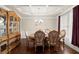 Formal dining room featuring a coffered ceiling, hardwood floors, and elegant furnishings at 1709 Grove Se Ct, Conyers, GA 30013