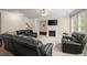Cozy living room featuring fireplace and large windows at 1709 Grove Se Ct, Conyers, GA 30013