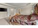 Spacious primary bedroom featuring tray ceiling, carpet floors, and elegant furniture at 1709 Grove Se Ct, Conyers, GA 30013