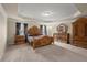 Spacious primary bedroom featuring tray ceiling, carpet floors, and elegant furniture at 1709 Grove Se Ct, Conyers, GA 30013