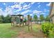 Community playground with climbing structure, slides, and swings at 1709 Grove Se Ct, Conyers, GA 30013