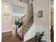 Staircase with wood railing, carpeted steps, and access to a living room area at 1709 Grove Se Ct, Conyers, GA 30013