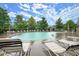 Relaxing community pool with lounge chairs and plenty of space for sunbathing at 1709 Grove Se Ct, Conyers, GA 30013