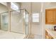 Well-maintained bathroom featuring a glass shower and vanity with storage space at 1870 Milfield Cir, Snellville, GA 30078