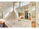 Bright bathroom featuring a large tub, mirrors, and plenty of vanity counter space at 1870 Milfield Cir, Snellville, GA 30078