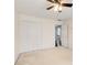 Bedroom showcasing neutral walls, standard closet, ceiling fan, and hallway access at 1870 Milfield Cir, Snellville, GA 30078
