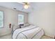 Bedroom showcasing neutral walls, a ceiling fan, and a sunny window at 1870 Milfield Cir, Snellville, GA 30078