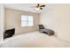 Bedroom with neutral walls, ceiling fan, and a chaise lounge by a sunny window at 1870 Milfield Cir, Snellville, GA 30078