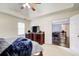 Bedroom featuring a tray ceiling, neutral walls, and a view to the open, wood-floored landing at 1870 Milfield Cir, Snellville, GA 30078