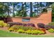 Kensington community entrance featuring a brick sign and colorful landscaping at 1870 Milfield Cir, Snellville, GA 30078
