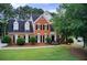 Charming two-story red brick home with a well-manicured lawn and mature trees at 1870 Milfield Cir, Snellville, GA 30078