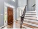Grand foyer featuring hardwood floors, a staircase with iron railings, and soaring ceilings at 1870 Milfield Cir, Snellville, GA 30078