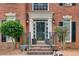 Inviting front entrance with brick steps, decorative columns, and elegant lighting fixtures at 1870 Milfield Cir, Snellville, GA 30078