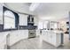 Bright kitchen features stainless steel appliances, white cabinets, island, and eye-catching backsplash at 1870 Milfield Cir, Snellville, GA 30078