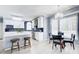 Bright kitchen with white cabinetry, stainless steel appliances, and adjacent breakfast nook at 1870 Milfield Cir, Snellville, GA 30078