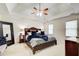 Inviting main bedroom with tray ceilings, a ceiling fan, and a beautiful queen bed at 1870 Milfield Cir, Snellville, GA 30078
