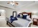 Inviting main bedroom with tray ceilings, a ceiling fan, and a beautiful queen bed at 1870 Milfield Cir, Snellville, GA 30078