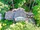 Aerial view of a home with a brown roof surrounded by lush greenery at 7310 Ne Wynhill Ne Dr, Atlanta, GA 30328