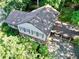 An aerial view of a house with an attached carport, enveloped by dense trees at 7310 Ne Wynhill Ne Dr, Atlanta, GA 30328