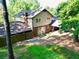 An aerial view of a backyard featuring lush greenery, a patio, and mature trees at 7310 Ne Wynhill Ne Dr, Atlanta, GA 30328