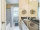 Bright bathroom featuring granite countertop, modern sink fixtures, and a shower/tub combination at 7310 Ne Wynhill Ne Dr, Atlanta, GA 30328