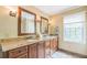 A bathroom with double sinks, granite countertops, and custom wood cabinets at 7310 Ne Wynhill Ne Dr, Atlanta, GA 30328
