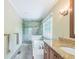 Bathroom featuring tiled walk-in shower, separate tub, large window, and granite counters at 7310 Ne Wynhill Ne Dr, Atlanta, GA 30328