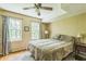 Well-lit bedroom with hardwood floor, ceiling fan, two windows, a bedside table and a bed at 7310 Ne Wynhill Ne Dr, Atlanta, GA 30328