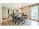 Bright dining room with hardwood floors, wainscotting, natural light and decorative chandelier at 7310 Ne Wynhill Ne Dr, Atlanta, GA 30328