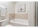 Bright bathroom features soaking tub with tile accents and modern fixtures at 855 Peachtree Ne St # 2913, Atlanta, GA 30308