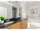 Bright bathroom features double vanity with granite countertop, soaking tub, and tiled shower at 855 Peachtree Ne St # 2913, Atlanta, GA 30308